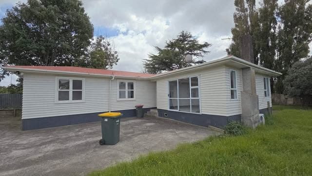 Exterior of the timber weatherboard home with corrugated iron roof