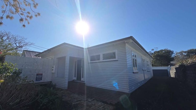 Front of the character bungalow with timber weatherboards and corrugated iron roof